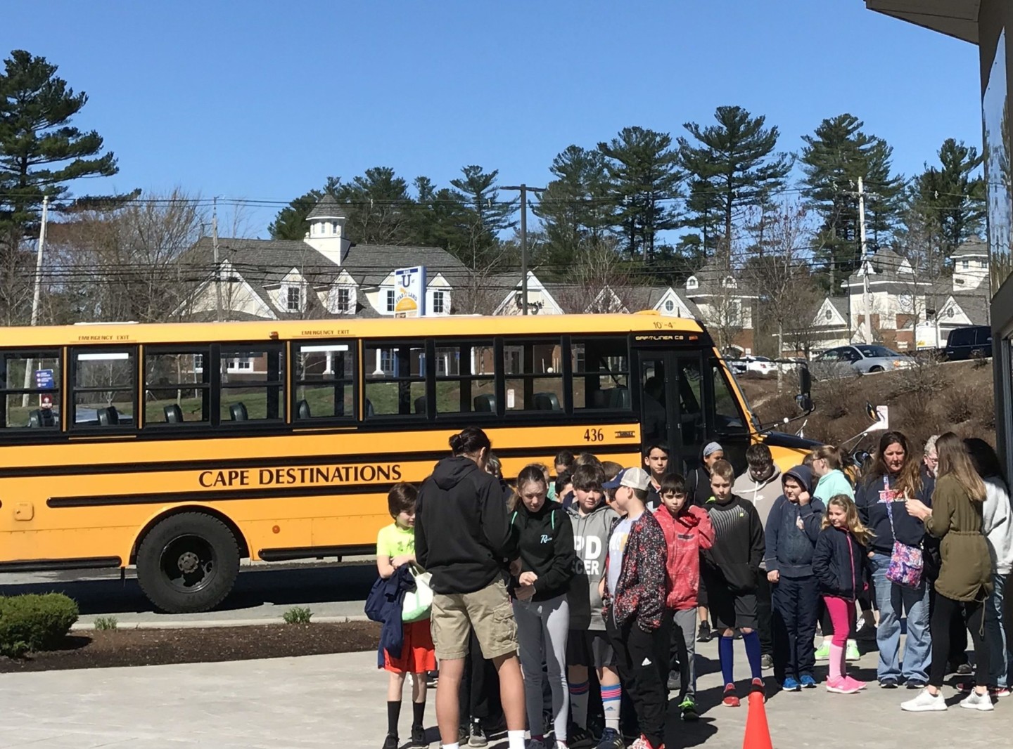 kids lined up in front of a school bus